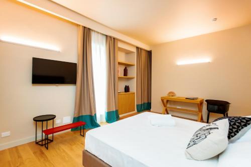 a hotel room with a bed and a desk at Hotel Politeama in Palermo
