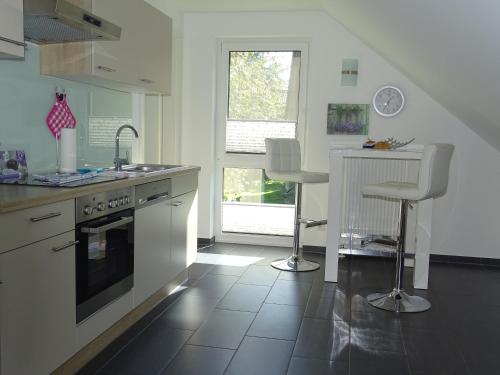 a kitchen with a sink and a stove top oven at TiWu - Ferienwohnungen in Steinhude
