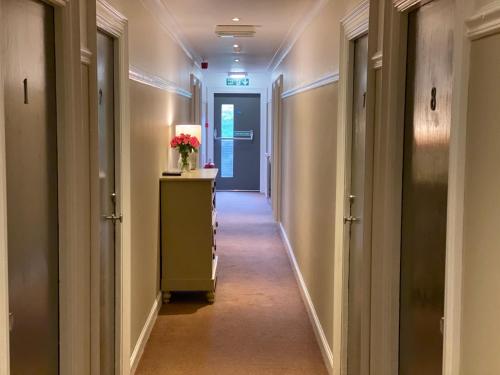 a corridor of a hotel with a hallway with two doors at Auld Mill House Hotel in Dunfermline