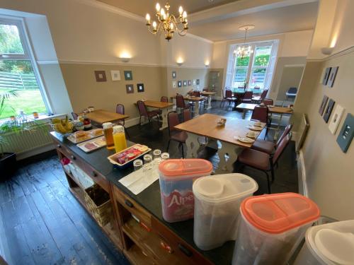 a kitchen and dining room with tables and chairs at Auld Mill House Hotel in Dunfermline