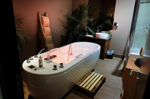 a bathroom with a bath tub and a sink at Kinsale Hotel & Spa in Kinsale