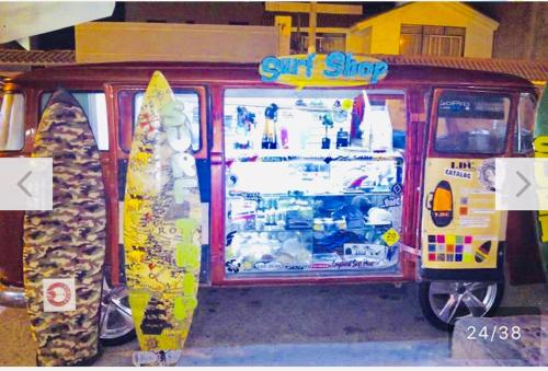 a surf shop with surfboards in front of it at Surf hostel My Friends in Huanchaco