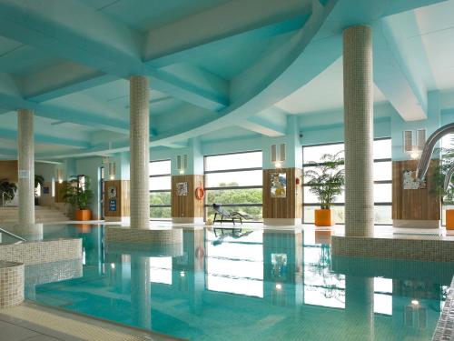 a swimming pool in a building with blue ceilings at Kinsale Hotel & Spa in Kinsale