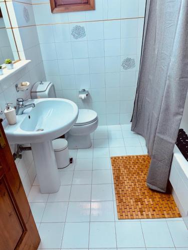 a bathroom with a sink and a toilet and a shower at Vravrona Family House in Artemida