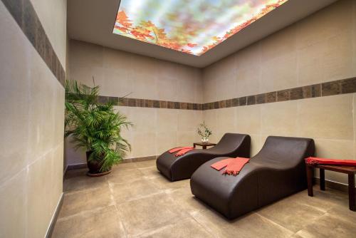 a waiting room with two leather chairs and a skylight at Sealife Lounge - Adult only in Antalya