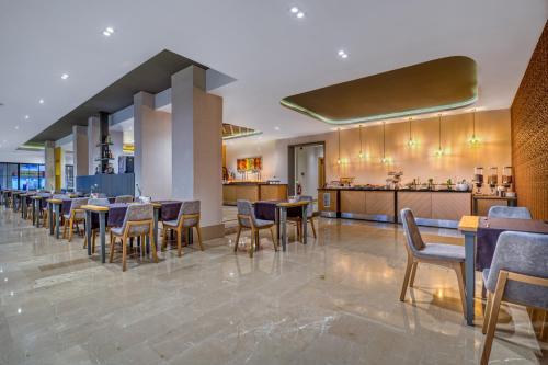 a restaurant with tables and chairs and a bar at Sealife Lounge - Adult only in Antalya