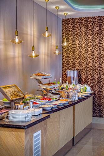 a buffet line with plates of food in a restaurant at Sealife Lounge - Adult only in Antalya