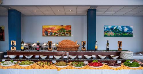 a buffet with different types of food on a table at Hotel des Mille Collines in Kigali