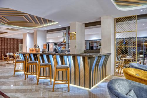 a bar in a restaurant with stools at Sealife Lounge - Adult only in Antalya