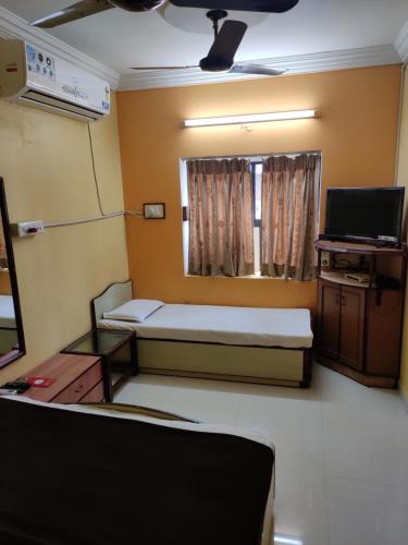 Un pat sau paturi într-o cameră la Hotel Tirupati
