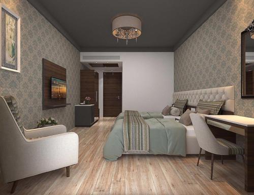 a bedroom with a bed and a table and chairs at Enrise By Sayaji Rau Indore in Indore