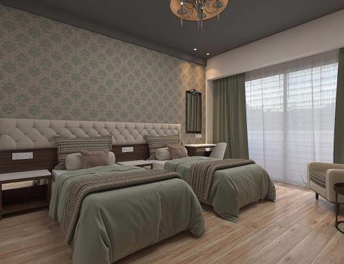a bedroom with two beds in a room at Enrise By Sayaji Rau Indore in Indore
