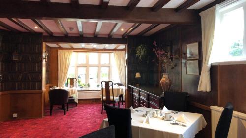 a dining room with a table and a window at Gable End Hotel in Great Yarmouth