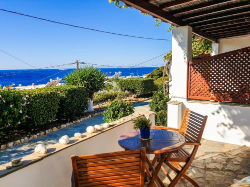 a patio with a table and chairs and the ocean at Studios Marfo in Batsi