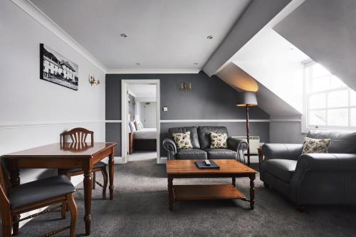 a living room with a couch and a table at The Falcon Hotel in Bude