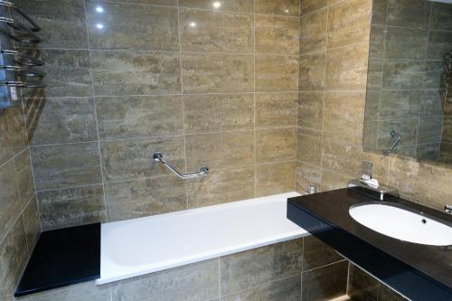 a bathroom with a bath tub and a sink at Kinsale Hotel & Spa in Kinsale
