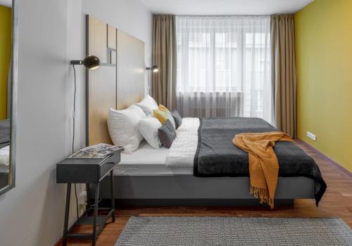 Postel nebo postele na pokoji v ubytování City Leaf Apartments by Adrez