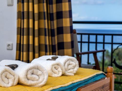 a pile of towels sitting on top of a bed at Calypso Studios in Amoudi