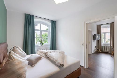 a living room with a white couch and a window at Villa Maria - Suiten & Appartement in Kufstein