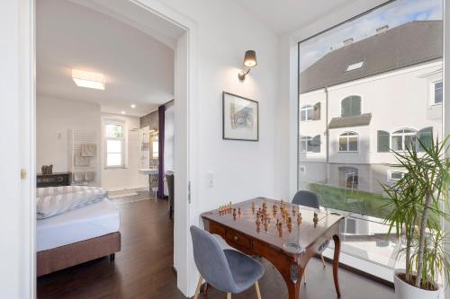 a room with a table and chairs and a bedroom at Villa Maria - Suiten & Appartement in Kufstein