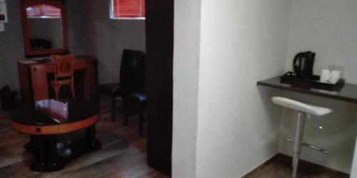 a room with a bathroom with a toilet and a counter at Waterside Lodge CC in Piet Retief