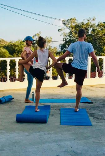 a group of people doing yoga on blue mats at Moby Dick Lodge Cascais in Cascais
