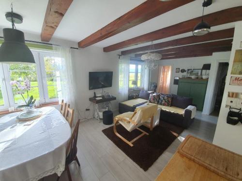 a living room with a table and a couch at Village House Flowerside in Gospić