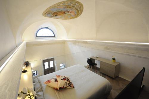 a bedroom with a bed and a desk and a window at HOLLIDAY CHARMING HOME in Trento
