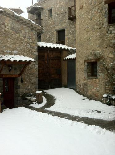 a yard covered in snow next to a building at Cal Gabriel in Tuixen