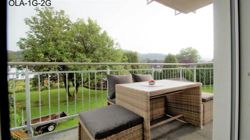 a porch with a table and chairs on a balcony at Overath Luxus Apartments nähe Köln City/Messe in Overath