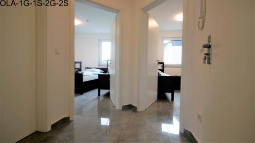 an open door to a room with a bedroom at Overath Luxus Apartments nähe Köln City/Messe in Overath