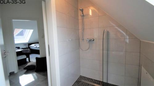 a bathroom with a shower with a glass door at Overath Luxus Apartments nähe Köln City/Messe in Overath