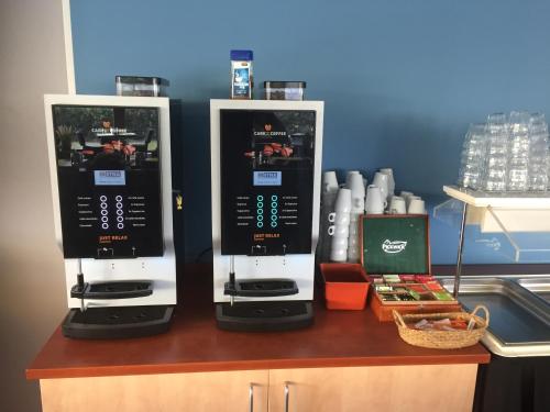two espresso machines sitting on top of a counter at Hotel Nes in Nes