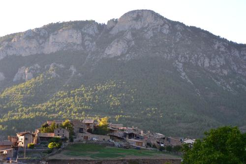 a village in front of a mountain with houses at Cal Gabriel in Tuixen