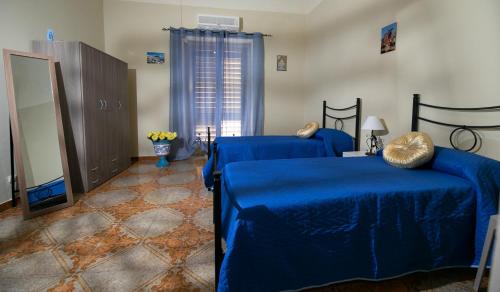 a bedroom with two blue beds at B&b Al Centro Nicosia in Nicosia