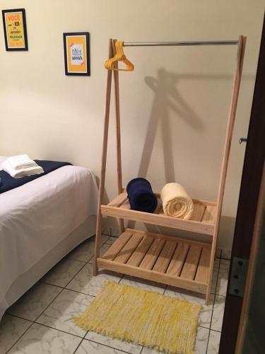 a bedroom with a bed and a room with a swing at Hospedagem Aconchego in Cunha