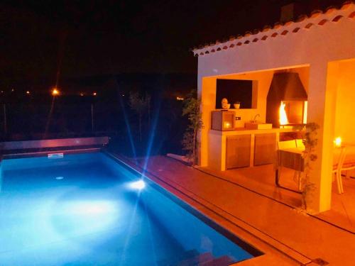 a swimming pool in front of a house at night at La Maison d AME - for the perfect stay at the Mont Ventoux in Malaucène
