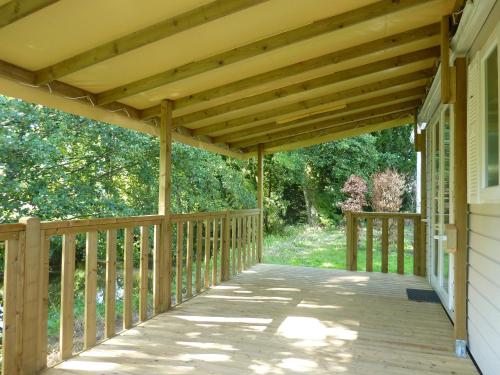 a wooden deck with awning on a house at Domaine De Sery in Bouttencourt