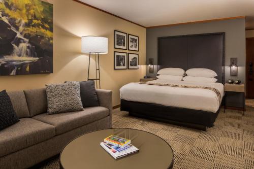 a hotel room with a bed and a couch at Skamania Lodge in Stevenson