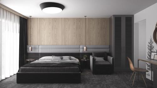 a bedroom with a bed and a chair at Vila 6aTo Hotel & Wellnes in Sofia