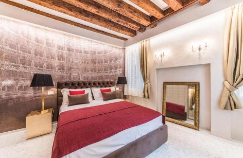 a bedroom with a bed and a painting on the wall at Rialto Luxury Flat in Venice