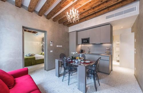 a kitchen and living room with a table and chairs at Rialto Luxury Flat in Venice