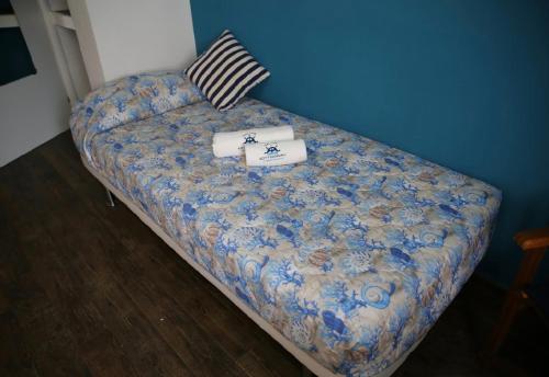 a bed in a room with a blue wall at House SottoCoperta in Civitavecchia