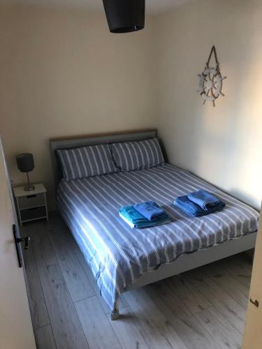 a bedroom with a bed with two towels on it at Fairview House in Portstewart