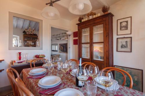 a dining room table with wine glasses on it at Fivestay Roof terrace overlooking the gulf in Monte Marcello