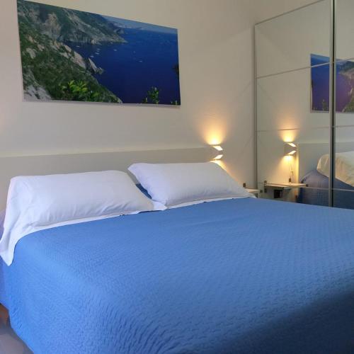 a bedroom with a large bed with two white pillows at Il Patio in Manarola