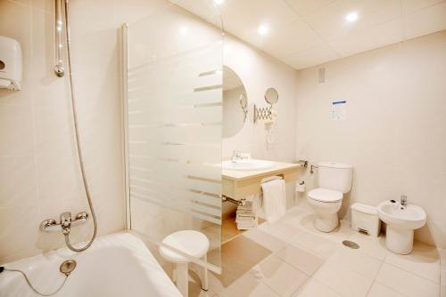 uma casa de banho com um chuveiro, um WC e um lavatório. em Hotel Montemar em Benidorm