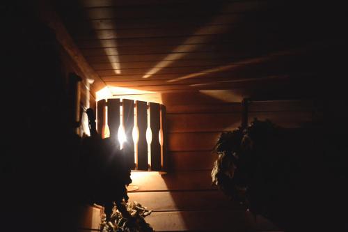 a light shines through the window of a house at night at Pirts Baudas in Sīveci