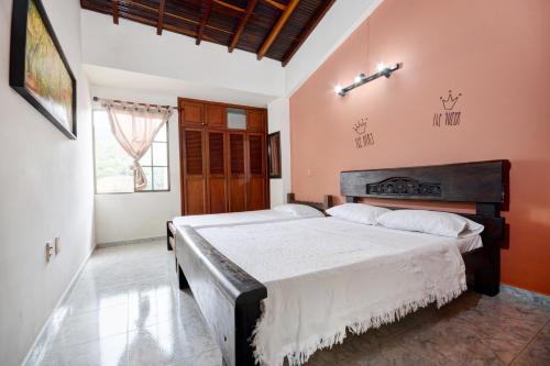a bedroom with a large bed in a room at Sam'S VIP Hostel San Gil in San Gil
