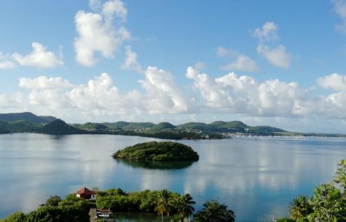 a small island in the middle of a large lake at Studio Évasion - Vue imprenable sur la mer in Le Marin